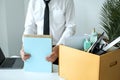 Business man employee packing document and picking up personal belongings into brown cardboard box Royalty Free Stock Photo