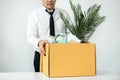 Business man employee stressful resignation from job while picking up personal belongings into brown cardboard Royalty Free Stock Photo