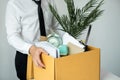 Business man employee stressful resignation from job while picking up personal belongings into brown cardboard Royalty Free Stock Photo