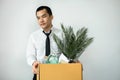 Business man employee stressful resignation from job while picking up personal belongings into brown cardboard Royalty Free Stock Photo