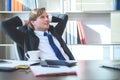 Business man feeling happy and relax working on laptop while sitting at his working place Royalty Free Stock Photo