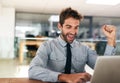 Business man, fist and celebrate with laptop, winning and promotion at startup with excited face. Young businessman Royalty Free Stock Photo