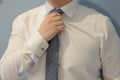 Business man fixing tie spotted on white shirt. On wedding day Groom fixing tie Royalty Free Stock Photo