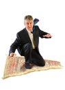 Business man flying on a magic carpet