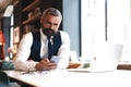 Business man in formal clothing using mobile phone. Serious businessman using smartphone at work Royalty Free Stock Photo