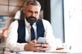 Business man in formal clothing using mobile phone. Serious businessman using smartphone at work Royalty Free Stock Photo