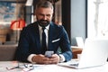 Business man in formal clothing using mobile phone. Serious businessman using smartphone at work Royalty Free Stock Photo