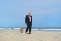 Business man with dog at the beach Royalty Free Stock Photo