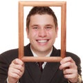Business man framing his face with wood frame Royalty Free Stock Photo