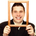 Business man framing his face with wood frame Royalty Free Stock Photo