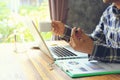 Business man of freelancer working using laptop computer and holding a pens in home office, Communication technology and Business Royalty Free Stock Photo