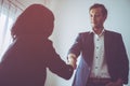 Business man gladly smile shaking hand with partner