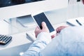 Business man on glass desk with phone Royalty Free Stock Photo