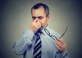 Business man with glasses suffering from eyestrain Royalty Free Stock Photo