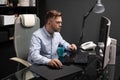 Business man with glasses working in office at computer table and drinking coffee from bright Cup Royalty Free Stock Photo