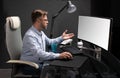 Business man with glasses working in office at computer table and drinking coffee from bright Cup Royalty Free Stock Photo