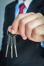 Business man hand holding keys Royalty Free Stock Photo