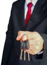 Business man hand holding keys Royalty Free Stock Photo