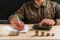 Business man hand holding a light bulb using a calculator to calculate cash flow. The idea of saving energy and accounting Finance Royalty Free Stock Photo