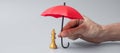 Business man hand holding red Umbrella cover Chess King figure. Business, Risk Management, Solution, economic regression,