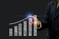Business man hand is pointing or pressing graph plan the growth financial icon symbol on virtual screen. Business Investment Royalty Free Stock Photo