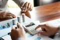 Business man hand putting coin stack for budget Saving money investment and financial accounting management or growing business Royalty Free Stock Photo