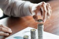 Business man hand putting coin stack for budget Saving money investment and financial accounting management or growing business co Royalty Free Stock Photo