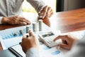 Business man hand putting coin stack for budget Saving money investment and financial accounting management or growing business co Royalty Free Stock Photo