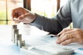 Business man hand putting coin stack for budget Saving money investment and financial accounting management or growing business co Royalty Free Stock Photo