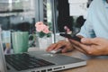 Business man hand using mobile smart phone and mouse computer laptop on table.searching internet technology. Social media online Royalty Free Stock Photo