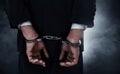 Businessman in handcuffs on smoke background Royalty Free Stock Photo