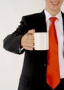 Business man handing a blank mug