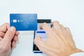 Business man hands holding a credit card and using smartphone for online shopping. Royalty Free Stock Photo