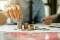 Business man hands putting coins on stack coin. saving money and investment concept Royalty Free Stock Photo