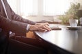 business man hands on a table with tablet, phone and cup of coffee in a office Royalty Free Stock Photo