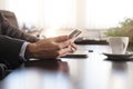 business man hands on a table with tablet, phone and cup of coffee in a office Royalty Free Stock Photo