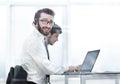 Business man in headphones sitting at his Desk Royalty Free Stock Photo