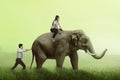 Business man help pushing elephant while his friend sit on it Royalty Free Stock Photo