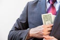 Business man hiding money in jacket pocket Royalty Free Stock Photo