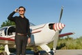 Business man with his airplanes. He is walking in the airport with the smart phone and making a call Royalty Free Stock Photo