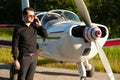 Business man with his airplanes. He is walking in the airport with the smart phone and making a call Royalty Free Stock Photo