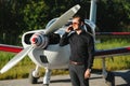 Business man with his airplanes. He is walking in the airport with the smart phone and making a call Royalty Free Stock Photo