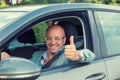 Business man in his car smiling, showing thumbs up Royalty Free Stock Photo