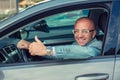 Business man in his car smiling, showing thumbs up Royalty Free Stock Photo