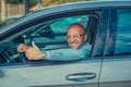 Business man in his car smiling, showing thumbs up Royalty Free Stock Photo