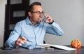 Business man at his desk drinking water in office Royalty Free Stock Photo