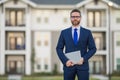 Business man hold laptop outdoor near home. Hispanic man with laptop outdoor. Businessman hold laptop computer front of