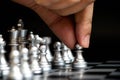 Business man hold pawn to first move in chess game Royalty Free Stock Photo