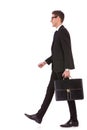 Business man holding brief case and walking Royalty Free Stock Photo