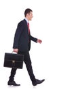 Business man holding brief case and walking Royalty Free Stock Photo